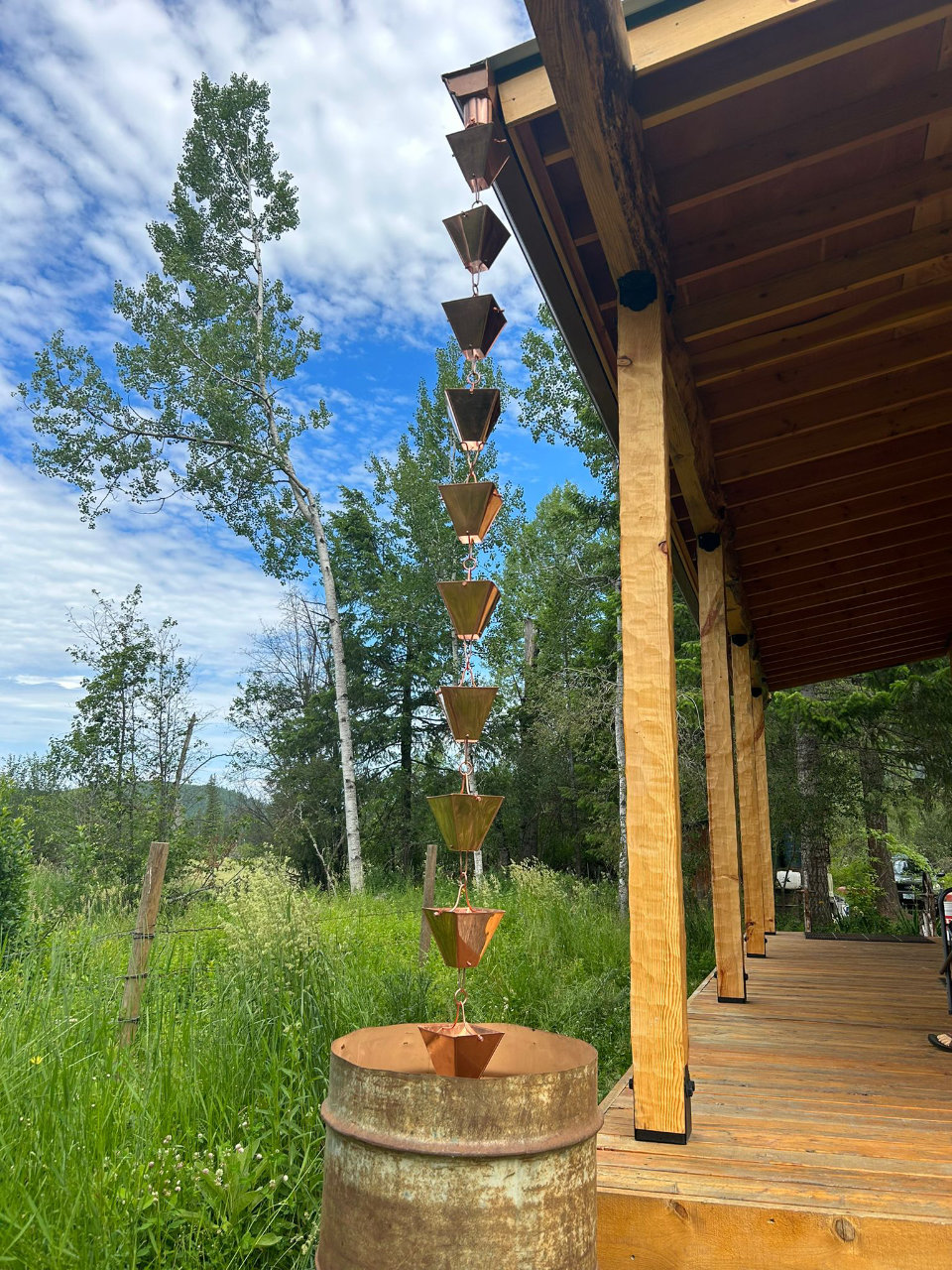 Decorative rain chain guiding water from gutter to ground